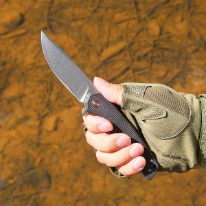 Outdoor close-up of black D2 Steel folding knife being held